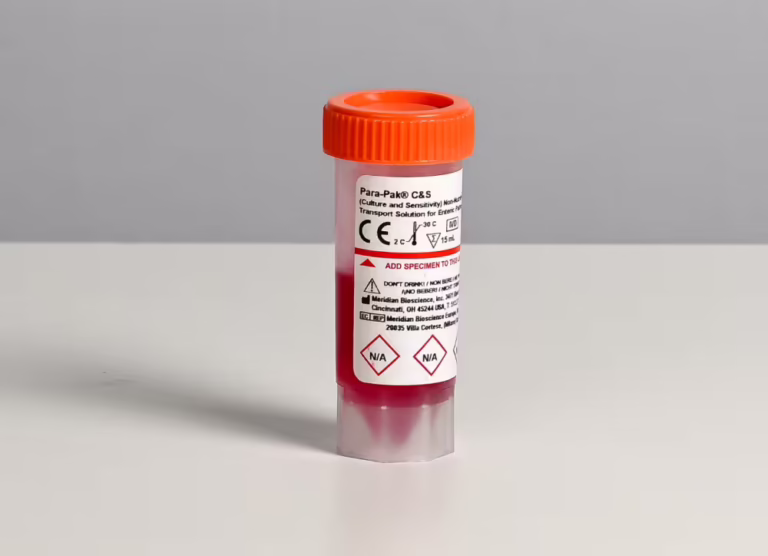 Medical specimen transport vial with an orange cap and red liquid on a neutral surface, labeled Para-Pak C&S for culture and sensitivity.