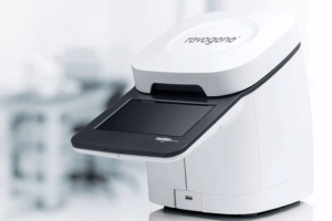 White desktop scanner with a dark scanning bed, sitting on a white office surface.