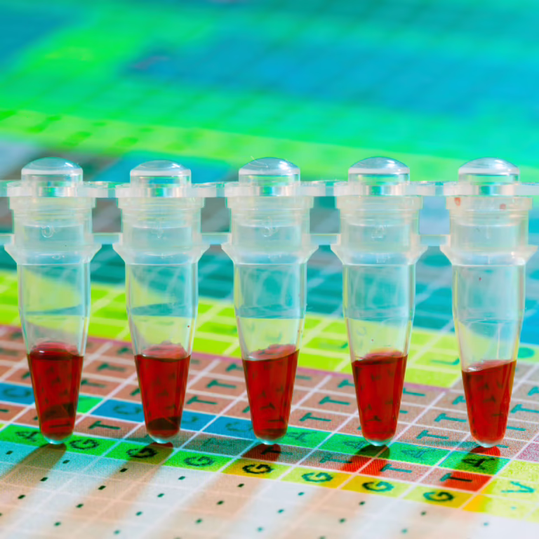 Row of capped test tubes with red liquid in a lab rack over a colorful grid chart