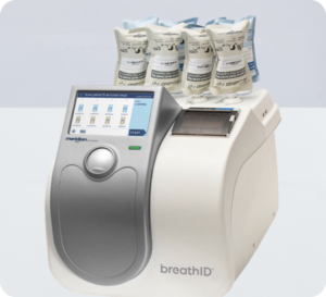 BreathID medical analyzer with multiple disposable breath collection bags on top. Used for breath-based diagnostic testing.
