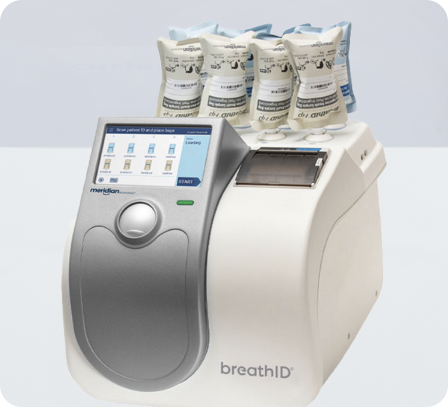 BreathID medical analyzer with multiple disposable breath collection bags on top. Used for breath-based diagnostic testing.