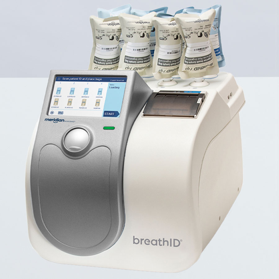 BreathID medical breath analyzer with sample bags loaded on top and a touchscreen control panel on the front