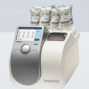 BreathID medical device with a touchscreen display and several sample bags loaded on top.